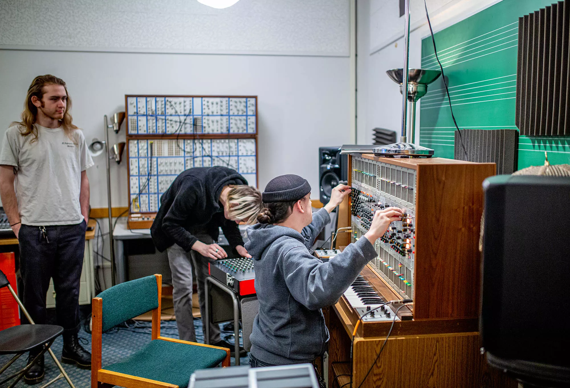 Students working together at a large synthesizer