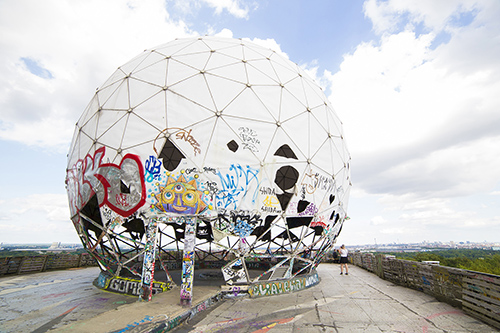 a geodesic sphere with grafitti at the base