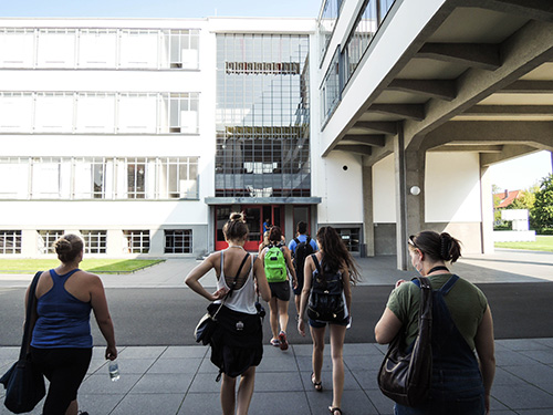 The back of students walking towards a building