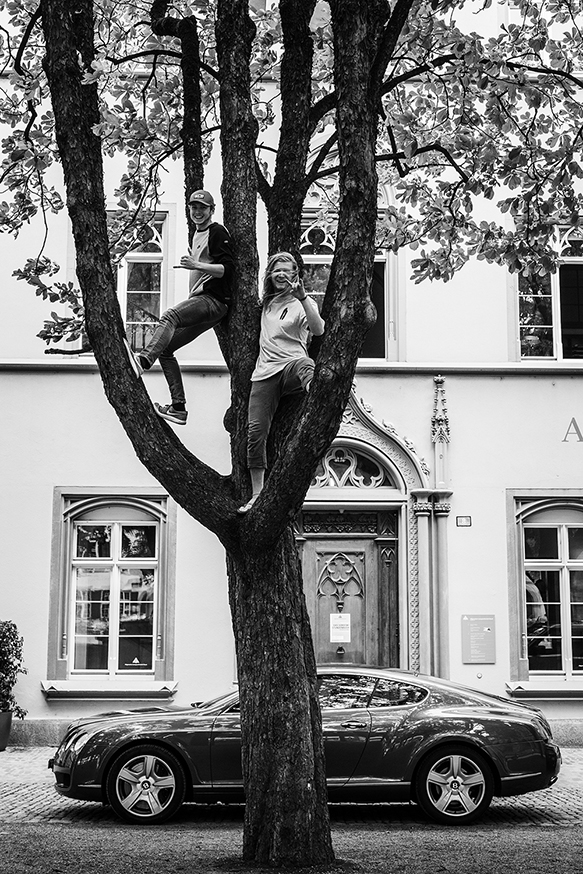 black and white photo of two students in a tree