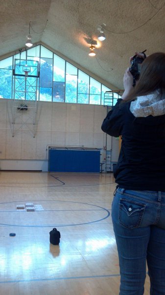 woman photographing a basketball court