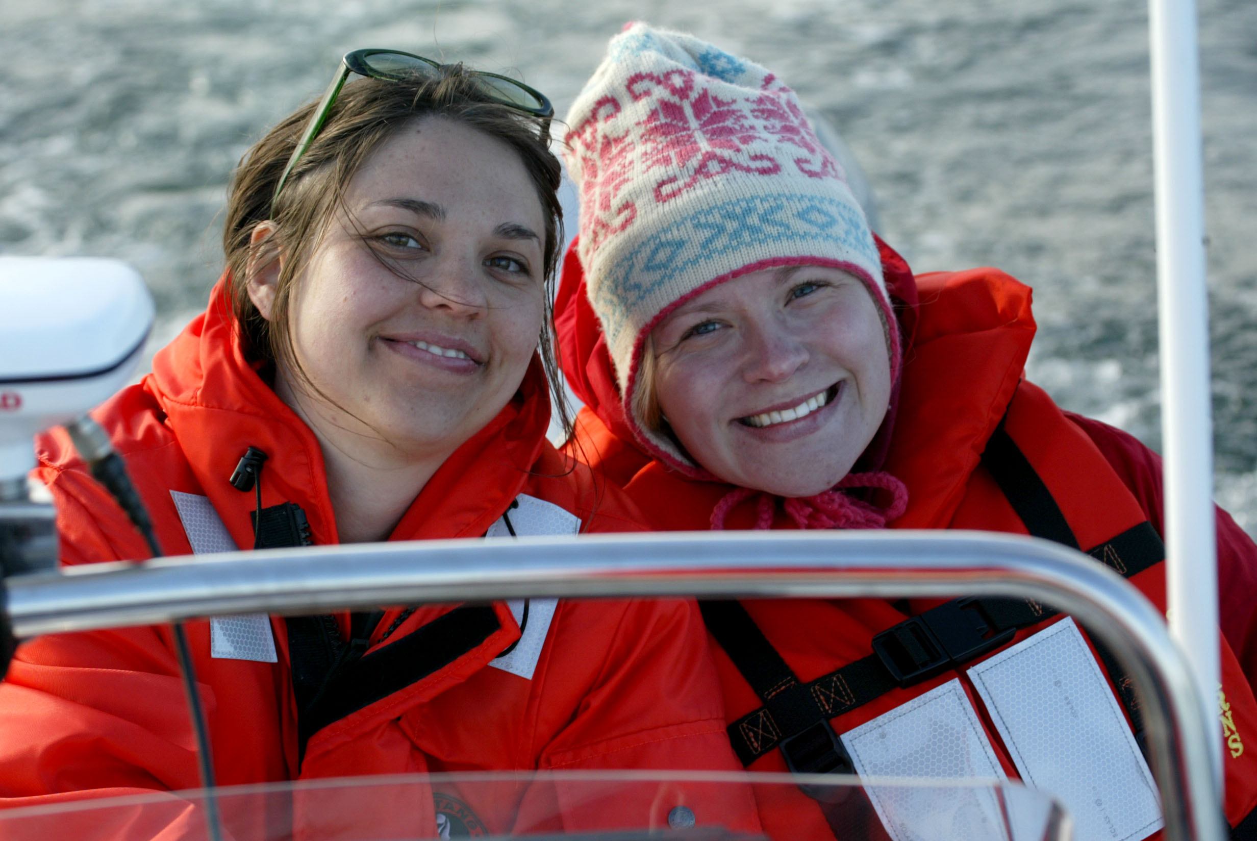 Two girls wearing red life jackets.