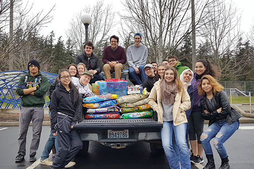 Group of student leaders ready to deliver donated dog food and supplies to Brigadoon Service Dogs.