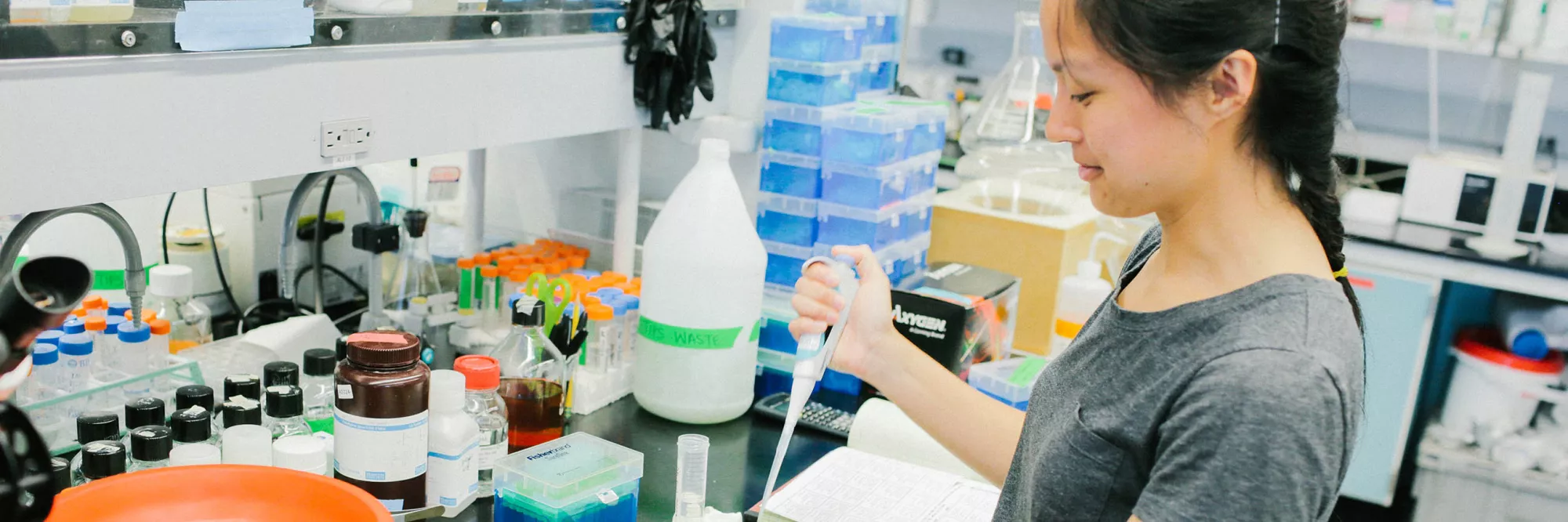 a student pipetting in a lab