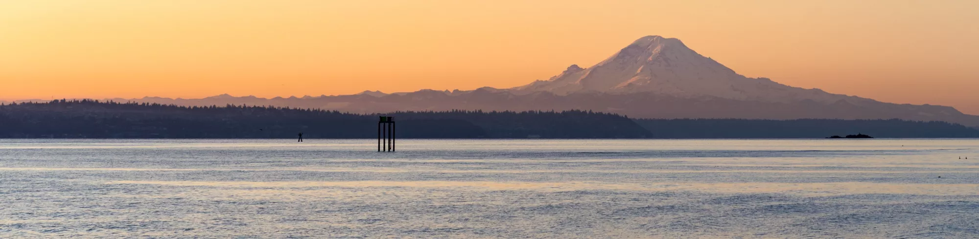 Photo of Bellingham Bay at dusk, with Mount Baker large in the background.