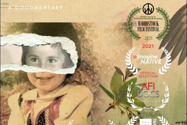 The film poster for, Daughter of a Lost Bird, a documentary. On it a young child is shown sitting with a sepia overlay. Where their eyes are the poster is ripped showing the child's eyes, nose, and forehead in black and white.
