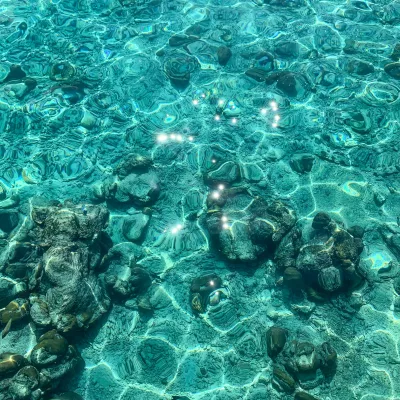 Turquoise sea floor with reflections from waves