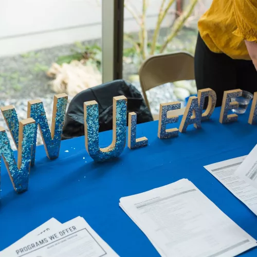 Large blue letters reading "WWU Leadership" sit on a table.