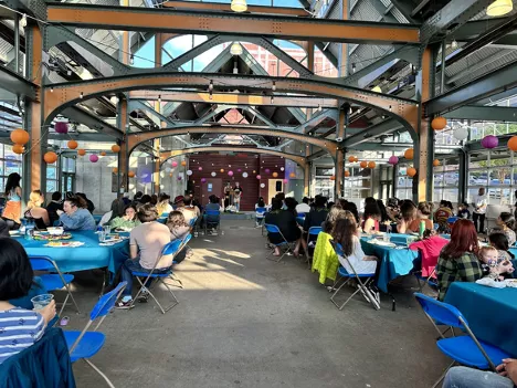 Rows of people sitting at tables for 2023's APIDA festival, held in Bellingham's Depot Market Square