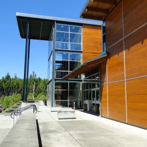 Tall glass entrance and front doors of the Poulsbo college building at OC Poulsbo, a WWU, Western washington University location in Poulsbo.